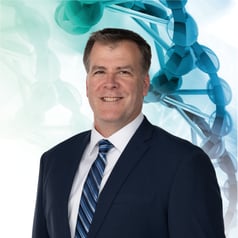 Rick Quinn Headshot with Medmarc dna helix as background